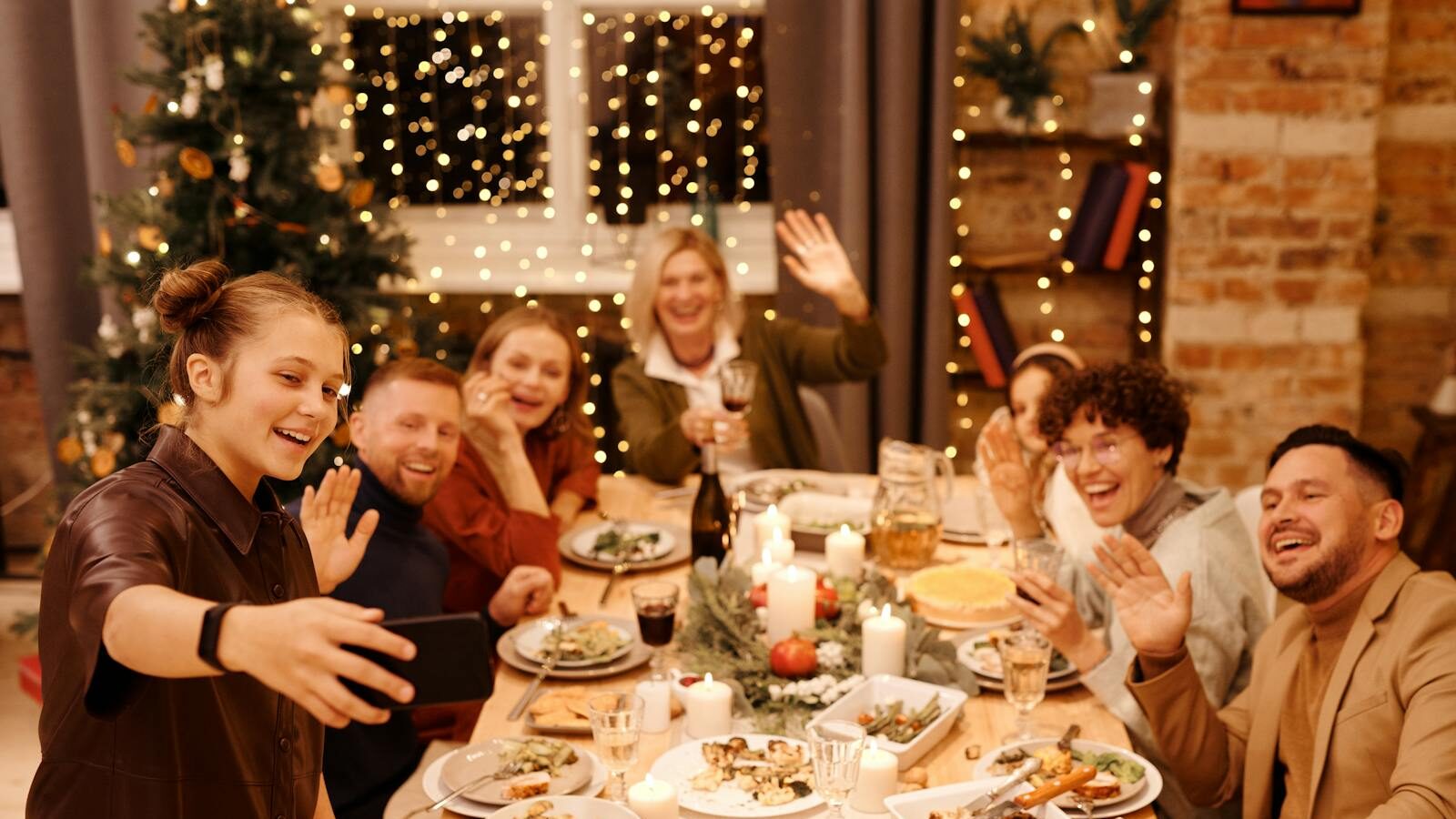 A joyful family gathering at a festive Christmas dinner table with decorations and cheerful faces.